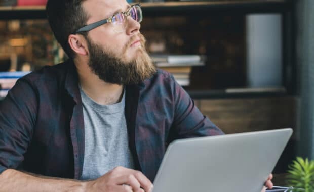 photo of man at computer for story about content distribution