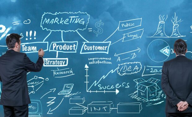 photo of two men looking at wall of text for marketing as an investment story